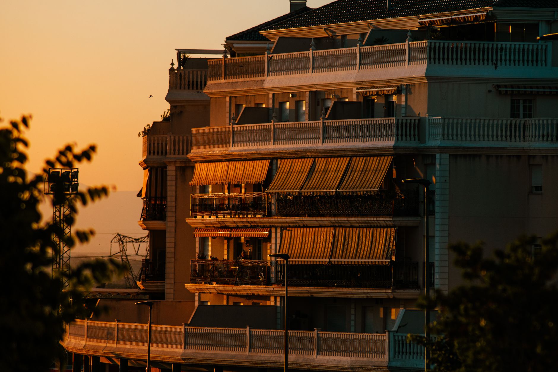 A warm, golden-hour apartment building exterior
