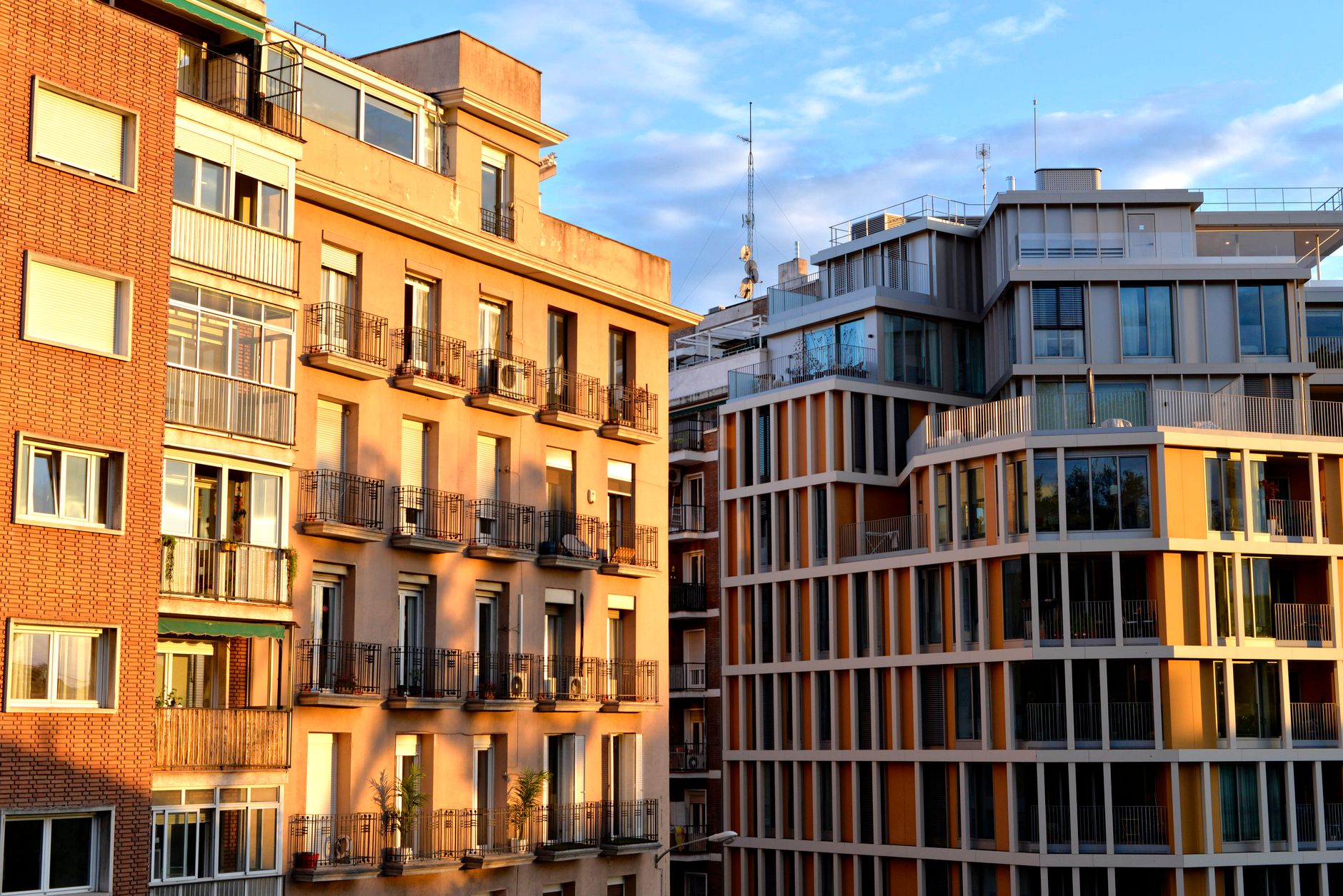 A warm, golden-hour apartment building exterior